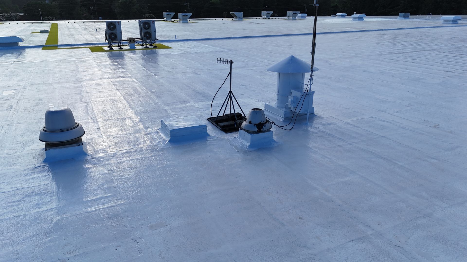 A white roof with a lot of vents on it