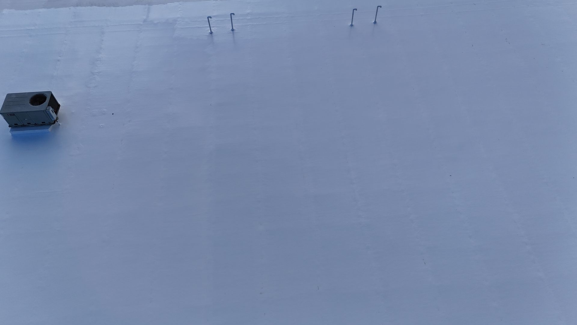 An aerial view of a roof with a chimney on it.