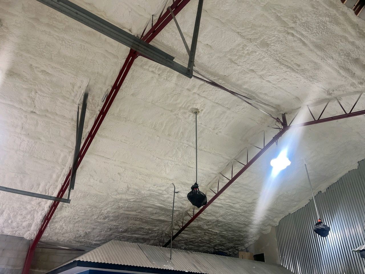 A ceiling with a lot of foam on it and a fan hanging from it.