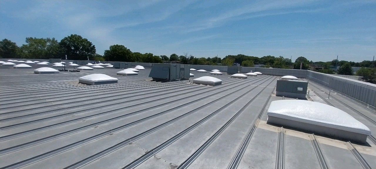 The roof of a building with a lot of skylights on it.