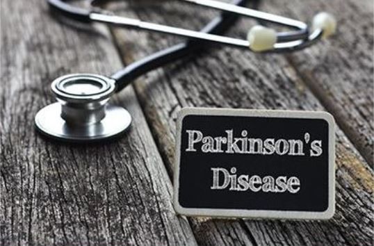 A stethoscope and a sign that says parkinson 's disease