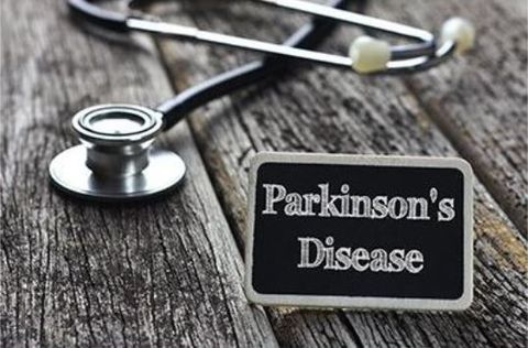 A stethoscope and a sign that says parkinson 's disease