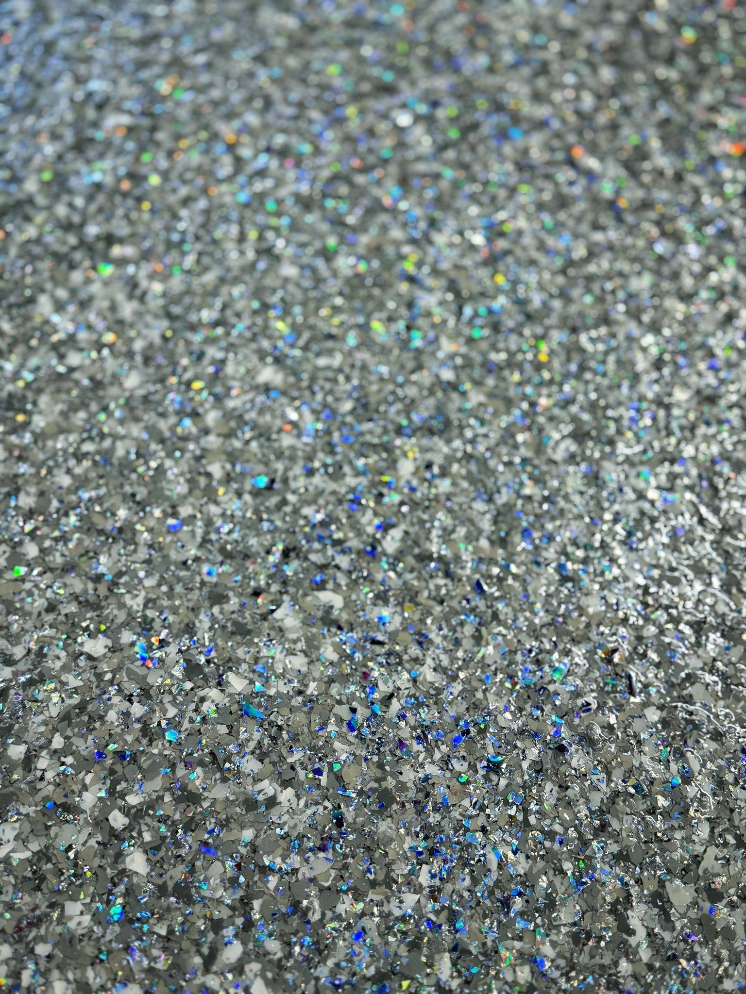 Silver glitter, shimmering and reflective, filling the frame.