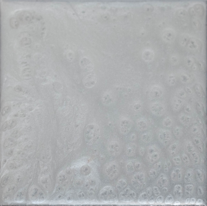 Square tile with a swirling, pearly, light gray design.
