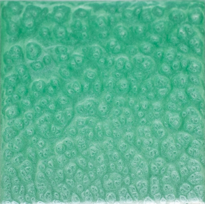Green square tile with a textured, bubbly surface.
