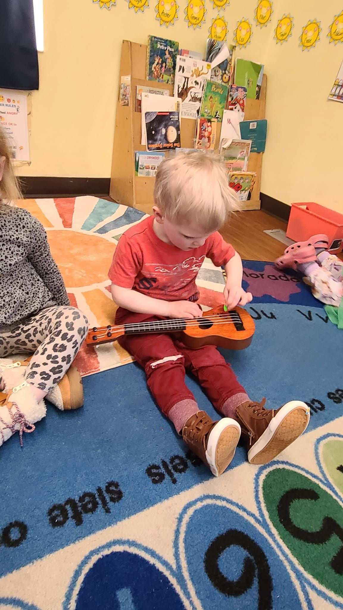 Kid holding a toy guitar