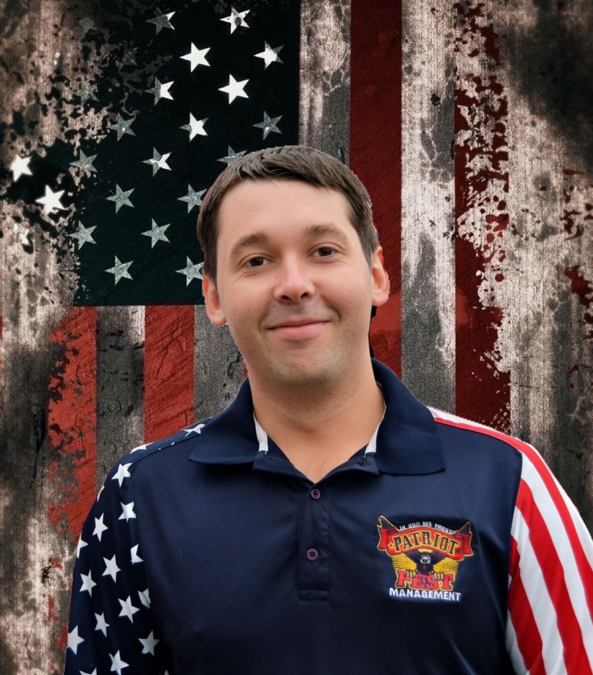 A smiling person wearing a blue polo with flag-themed sleeves against a backdrop of a distressed American flag.