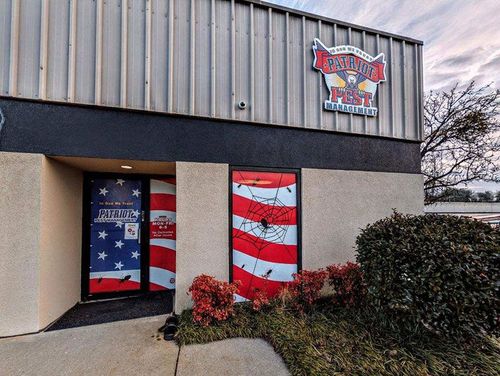 Exterior of Galvez Post, with American flag-themed doors. A logo is visible above the entrance.