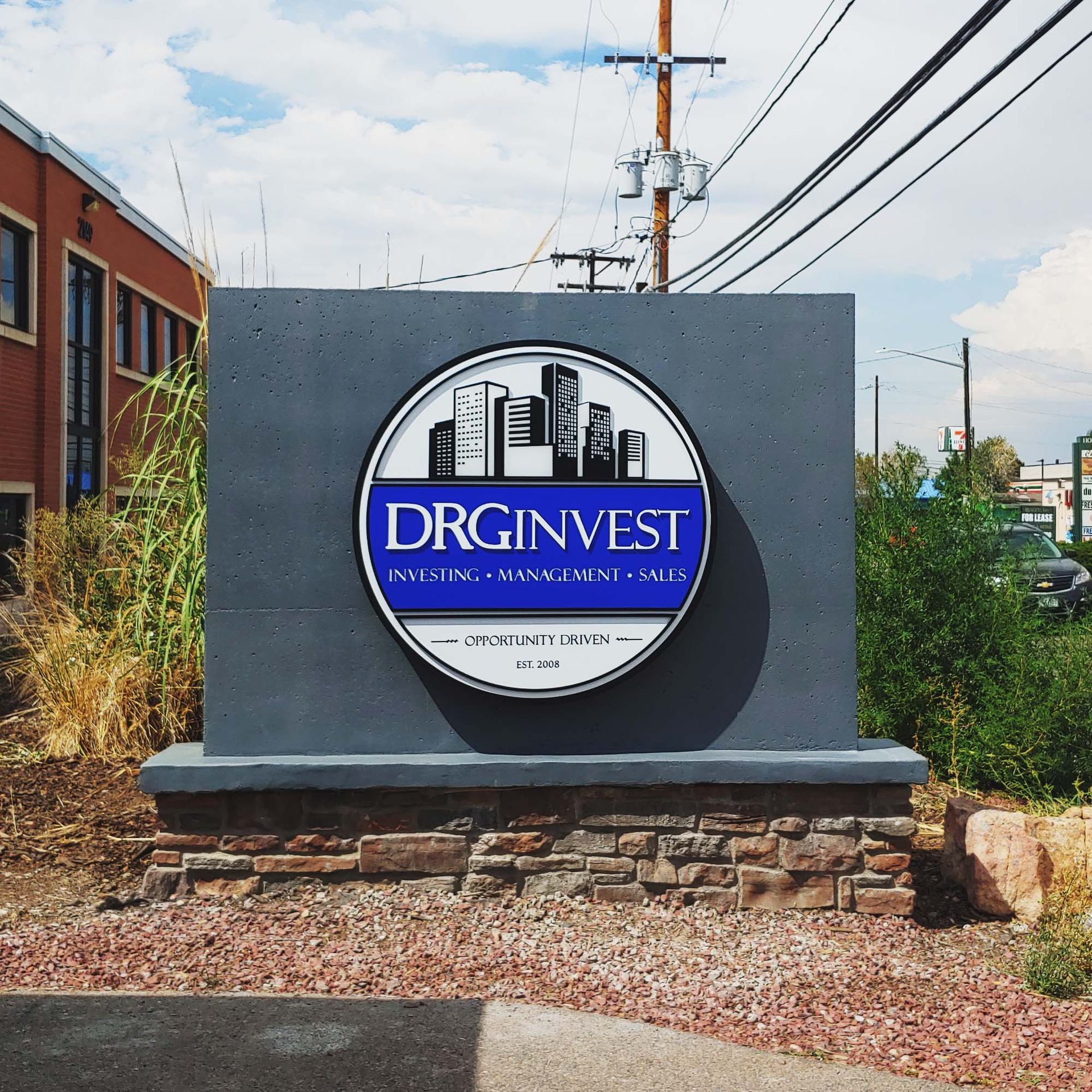  Monument Ground Sign Polished Concrete Halo Illuminated Brand Logo with Facelit Push Through Acrylic Face DRG Invest Property Denver Colorado