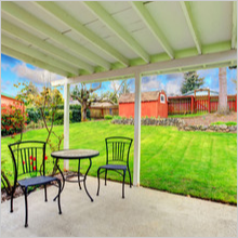 pergola with patio table set overlooking beautiful green lawn