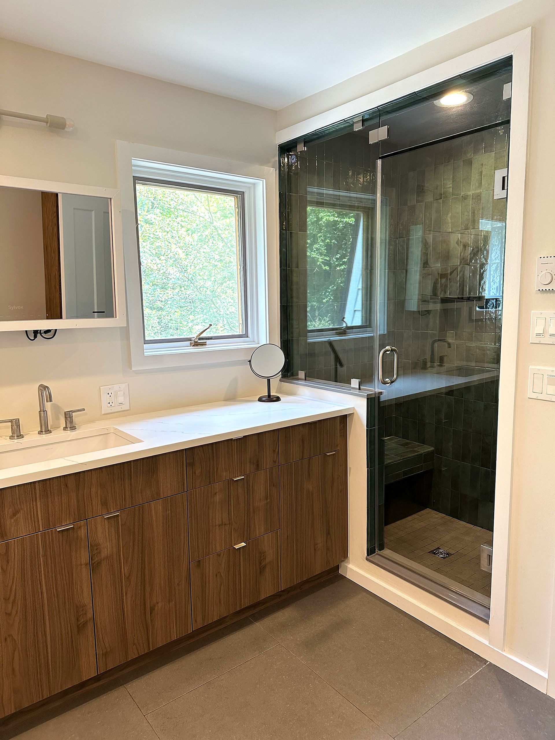 A modern bathroom with a wooden vanity