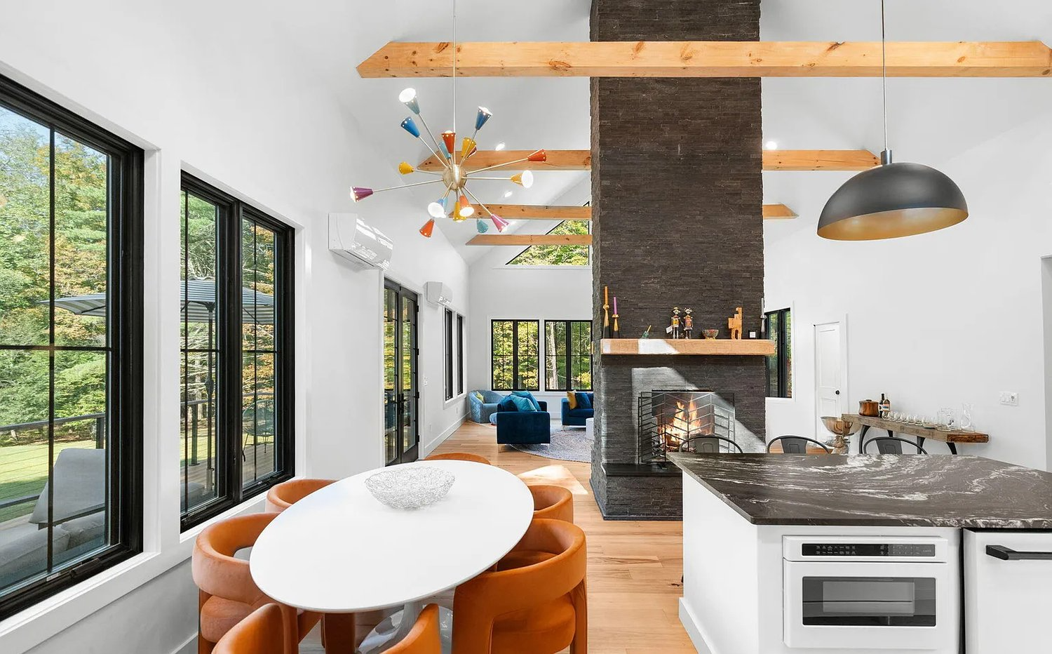 A kitchen with a table and chairs and a fireplace.