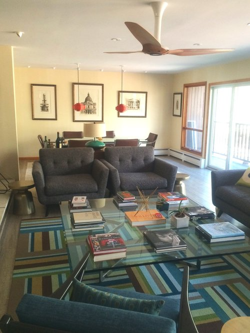 A living room filled with furniture and a ceiling fan