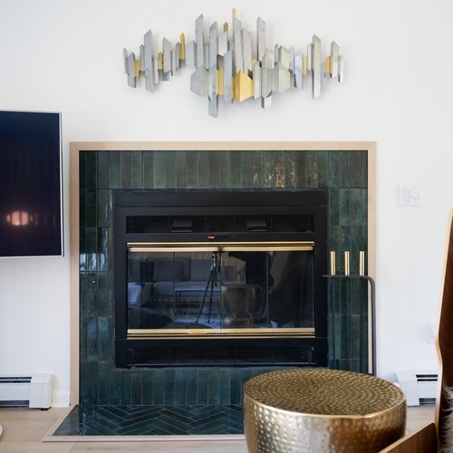 A living room with a fireplace and a television