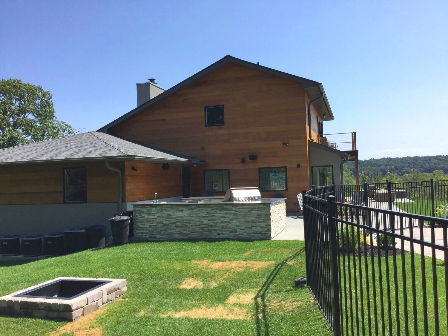 A large house with a fire pit in front of it.