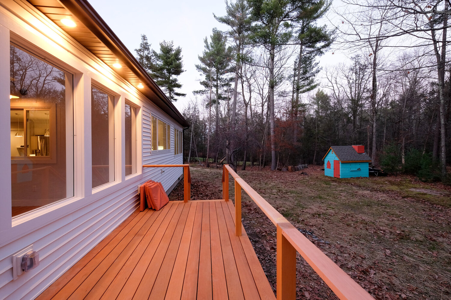 A house with a wooden deck in front of it