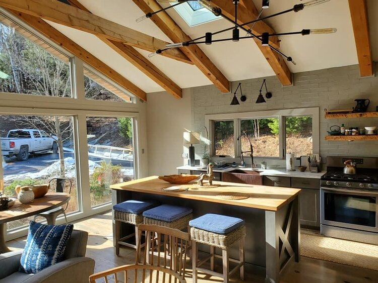 A kitchen with a large island and a lot of windows