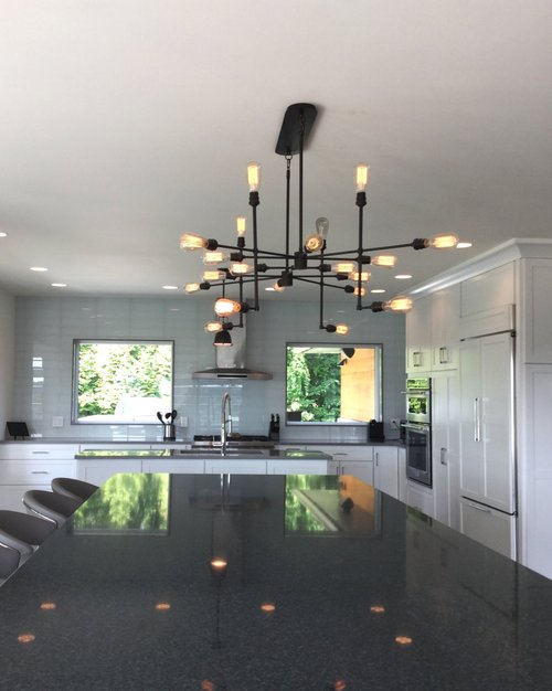 A kitchen with a large chandelier hanging from the ceiling
