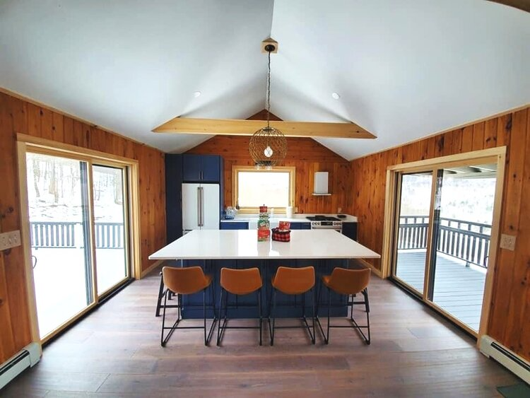 A large kitchen with a large island and stools