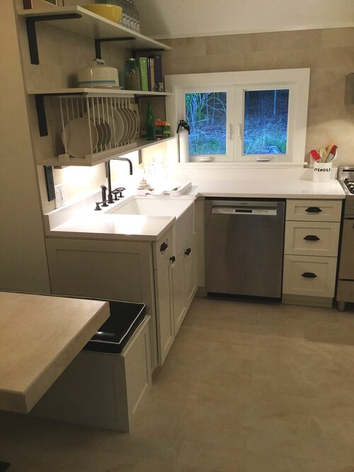 A kitchen with a sink , stove and dishwasher