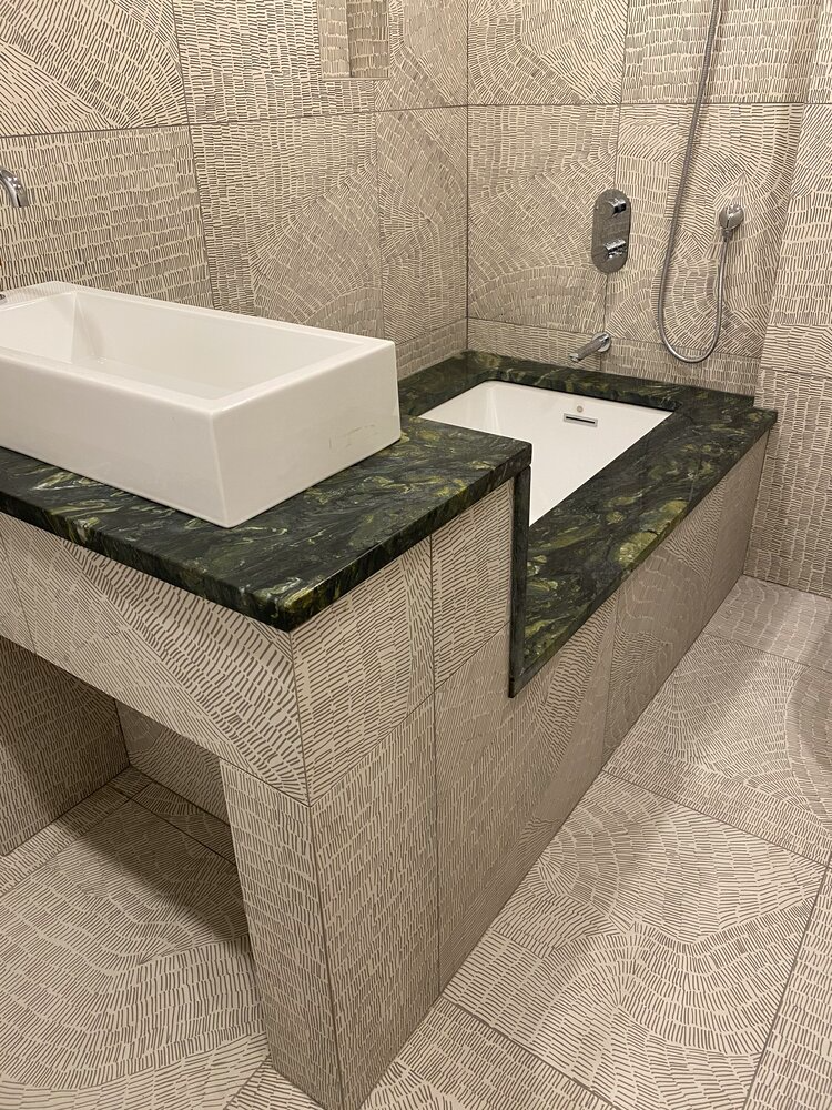 A bathroom with a sink , bathtub and shower.