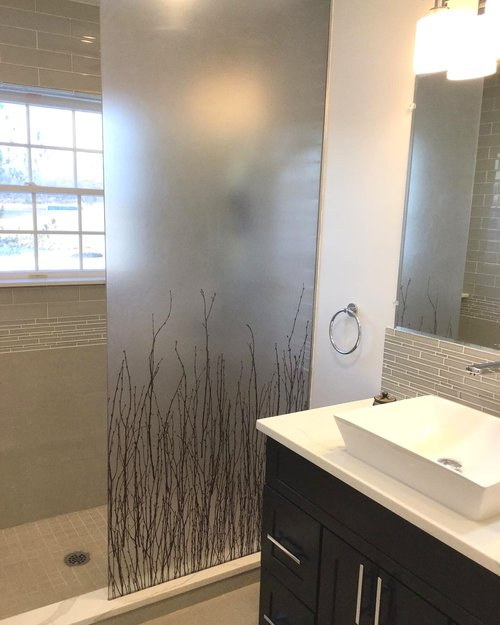 A bathroom with a sink and a walk in shower