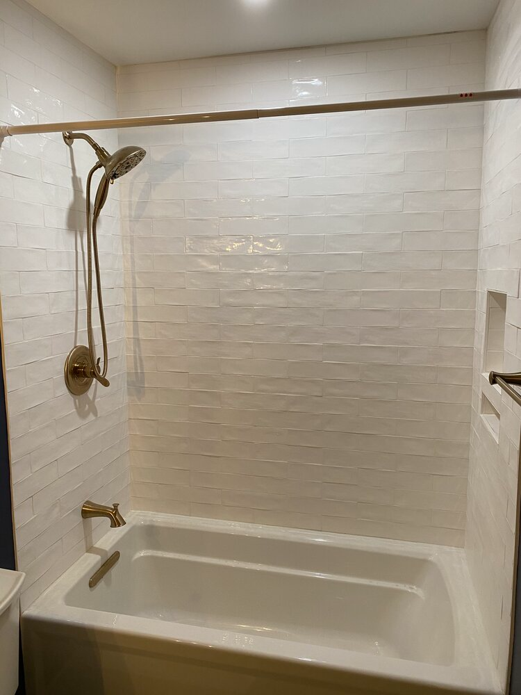 A bathroom with a bathtub and a shower.