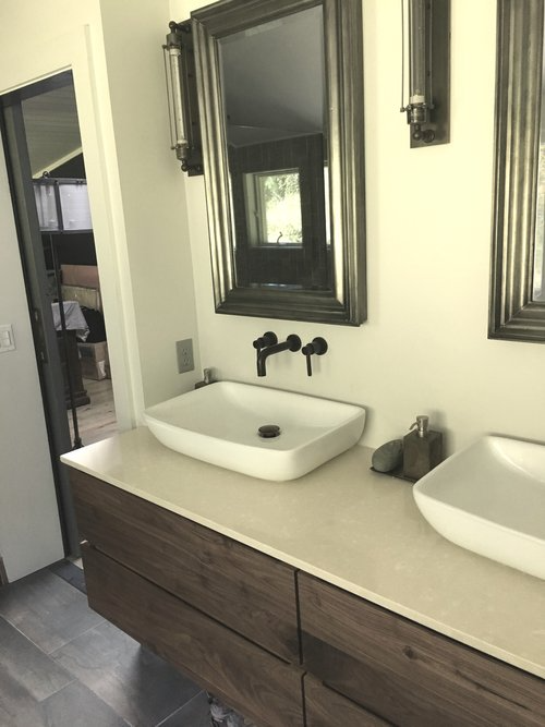 A bathroom with two sinks and two mirrors