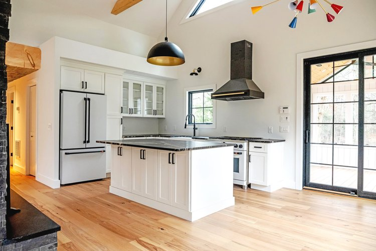There is a large island in the middle of the kitchen.