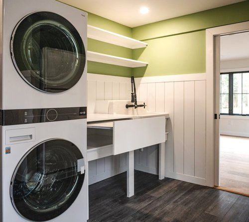 A laundry room with a washer and dryer stacked on top of each other