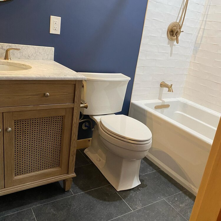 A bathroom with a toilet , sink and bathtub