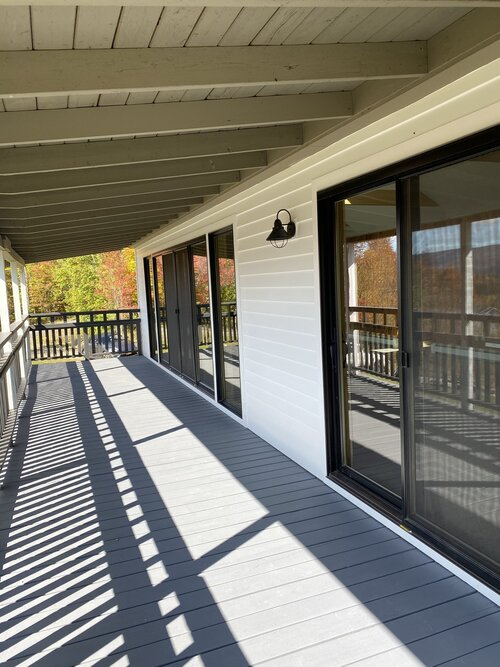 A balcony with sliding glass doors and a railing