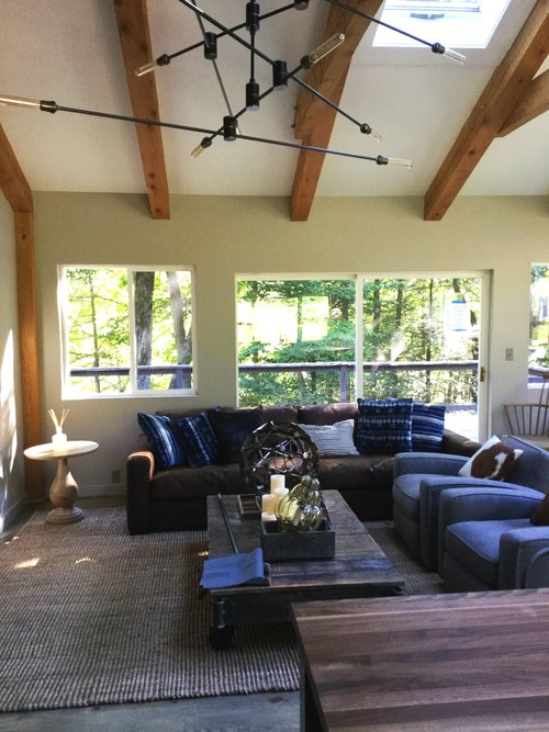 A living room with a lot of furniture and a skylight