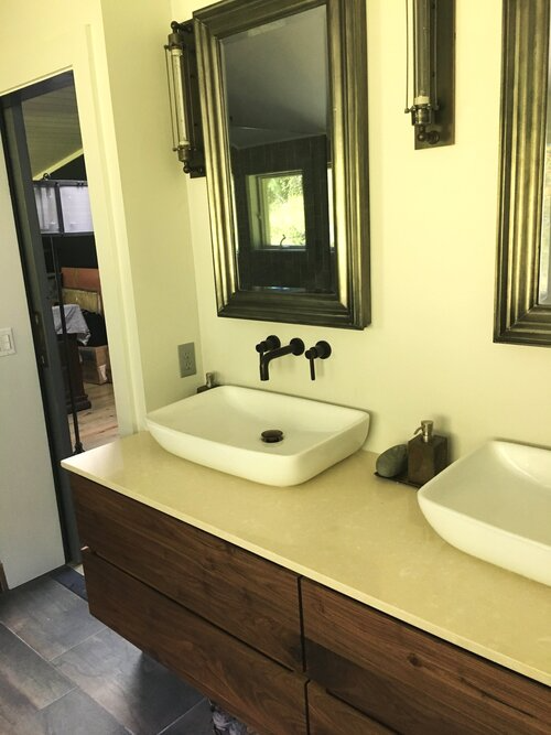 A bathroom with two sinks and two mirrors