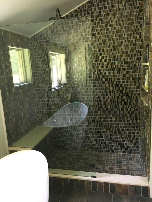 A bathroom with a walk in shower and a bathtub