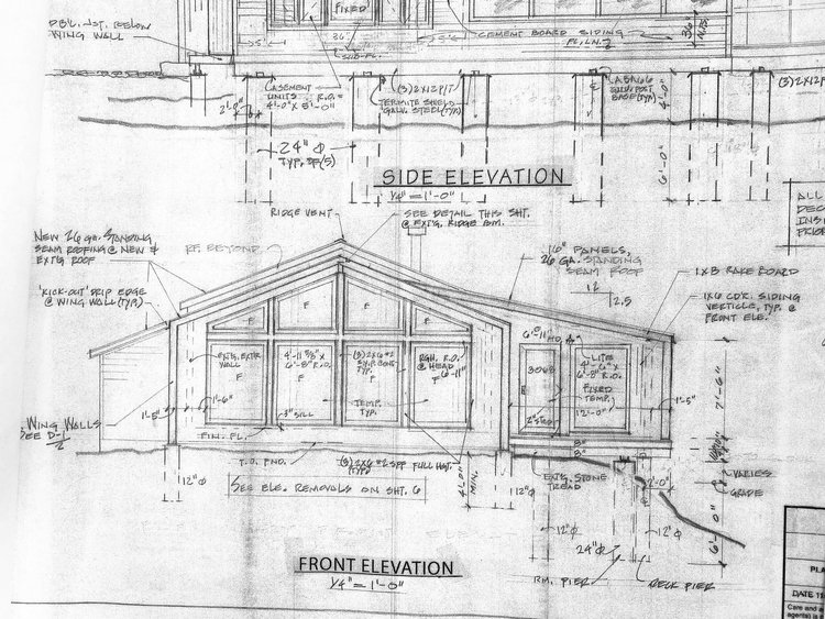 A black and white drawing of the front elevation of a house