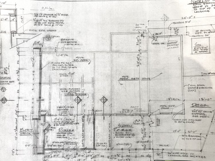 A black and white drawing of a building with measurements