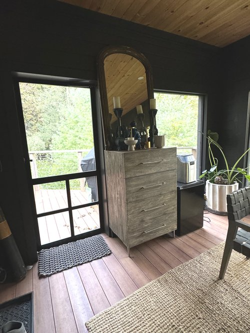 A room with a dresser and a mirror in it