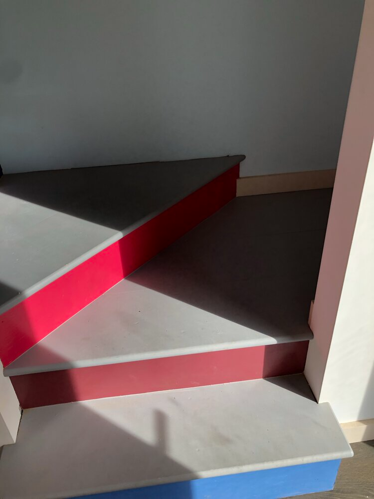 A set of stairs with red white and blue steps