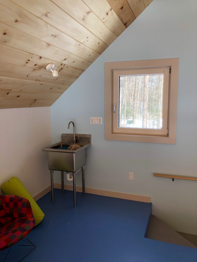 A room with a sink and a window in it