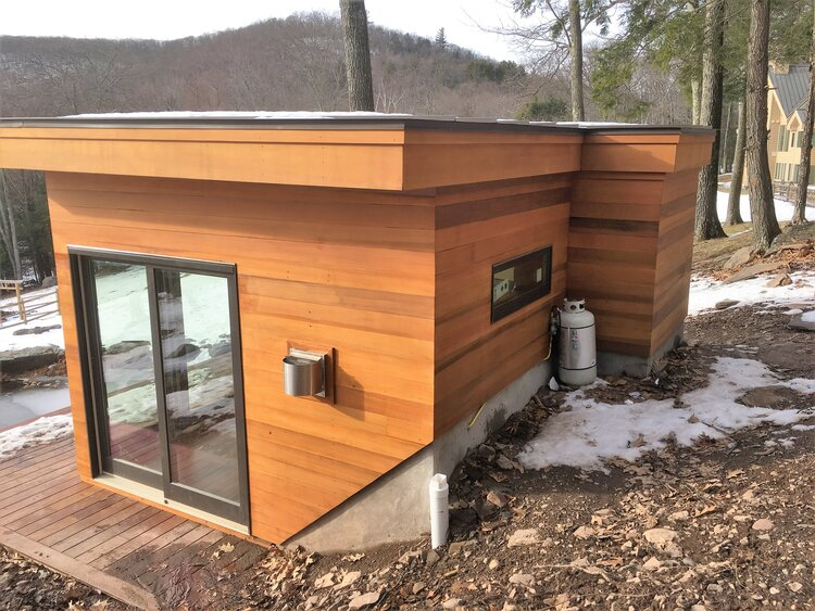 A small wooden house with a sliding glass door