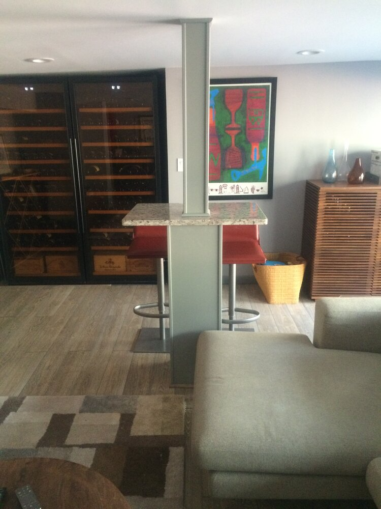 A living room with a couch a table and a picture on the wall