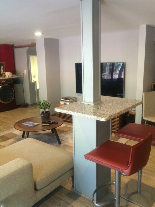 A living room with a table and chairs and a couch