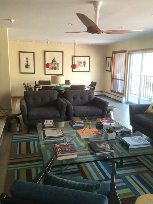 A living room filled with furniture and a ceiling fan