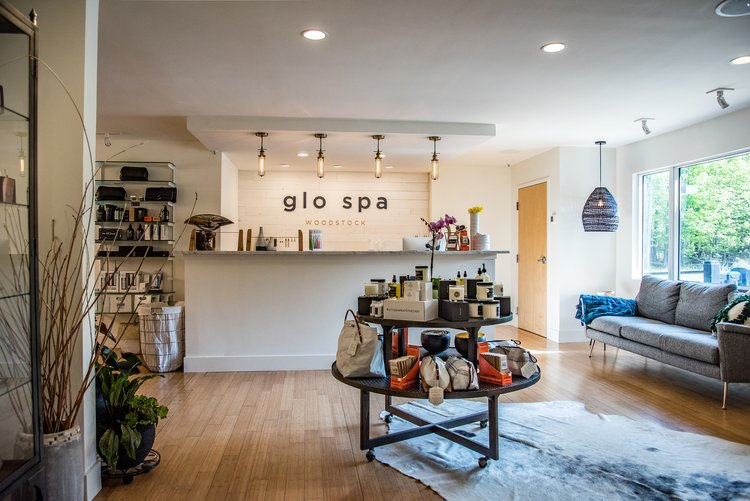 A living room with a couch , table , and counter in a spa.