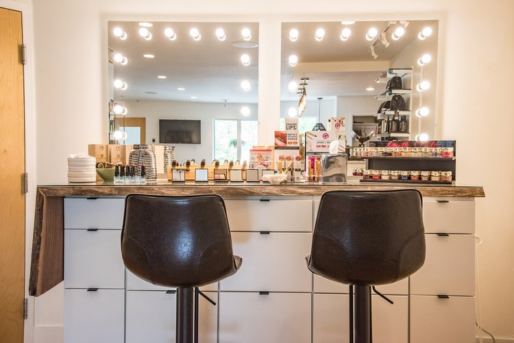 Two bar stools are sitting in front of a mirror in a room.