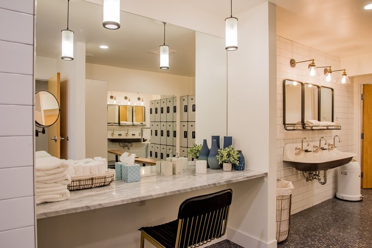 A bathroom with a large mirror and a sink.