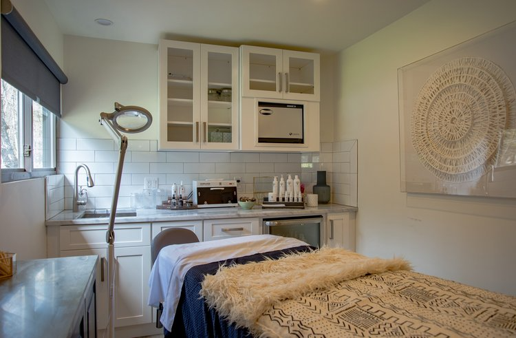 There is a massage table in the middle of the room.