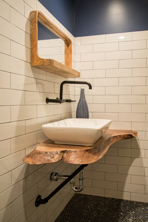 A bathroom with a sink and a mirror on the wall.