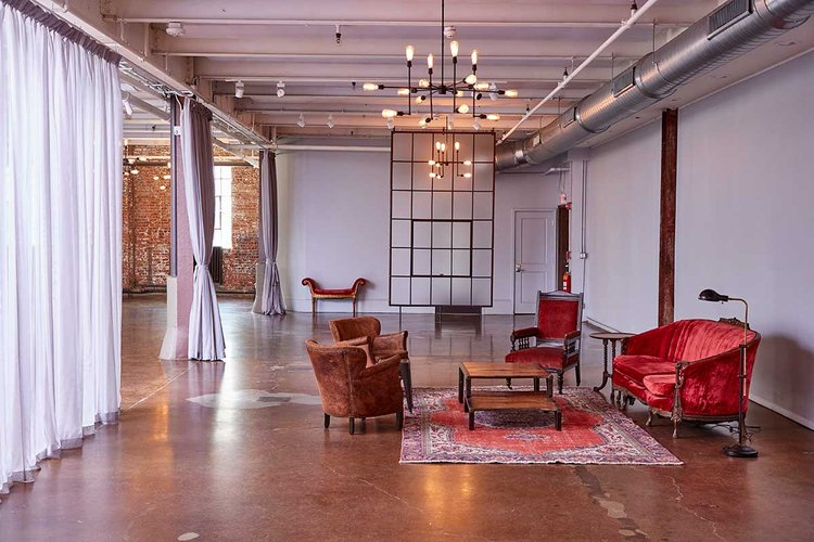 A living room with a couch , chairs , and a table.